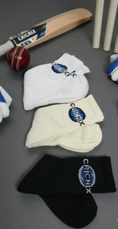 Cricnix sports socks whit Cricnix branded cricket equipment including a bat, ball, helmet, and socks on a gray surface.